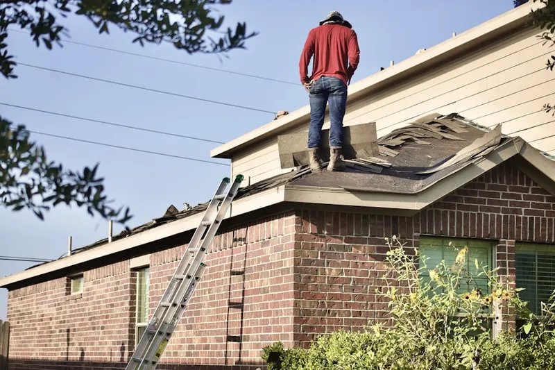Professional roofer working on a residential roof in Village of Merrick Park